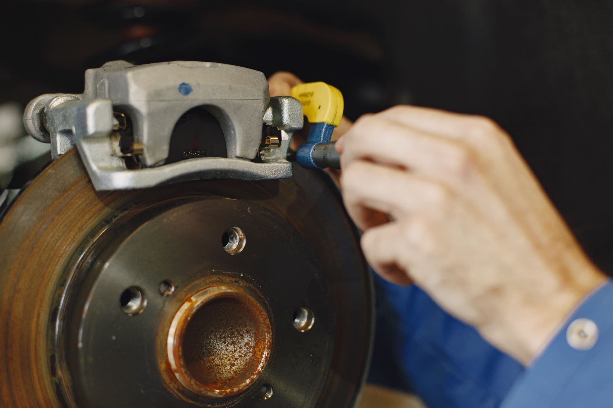 Close-up of a disc brake on a car in the workshop